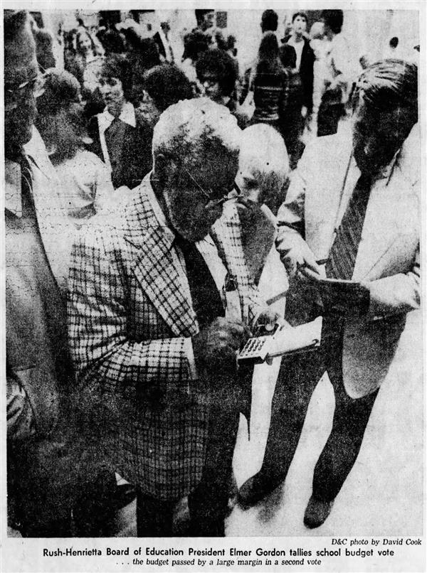 1976 newspaper photo of Elmer Gordon adding up votes after the 1976 budget vote